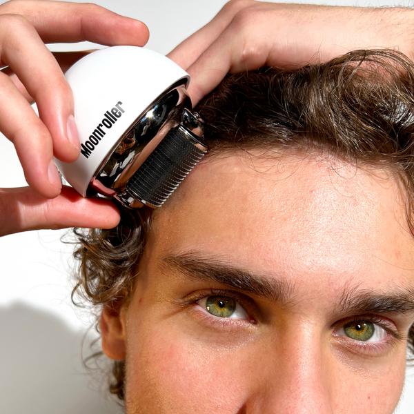 Man using the Copenhagen Grooming Moonroller on his scalp