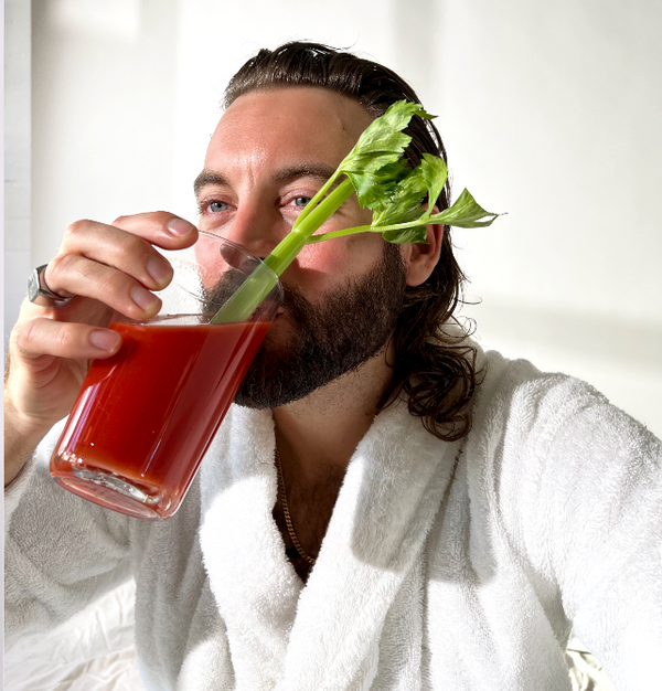 man drinking drink with widow's peak